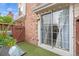 Charming back patio with artificial turf, sliding door, and decorative string lights at 12142 Bannock Cir # B, Denver, CO 80234