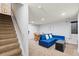 Finished basement with a cozy seating area and staircase to upper level at 12142 Bannock Cir # B, Denver, CO 80234