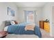 Comfortable bedroom showcasing a well-made bed, dresser, and natural light from the window at 12142 Bannock Cir # B, Denver, CO 80234