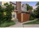 Charming townhouse showcasing a brick chimney and a wooden fence for added privacy at 12142 Bannock Cir # B, Denver, CO 80234