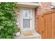 Close up of the entrance to 12142B with a white trimmed storm door and welcome mat at 12142 Bannock Cir # B, Denver, CO 80234