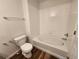 Clean bathroom featuring a white toilet, bathtub and white tiles, providing a comfortable and functional space at 12753 Ivanhoe St, Thornton, CO 80602