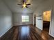 Bright bedroom with a ceiling fan, wood floors, and a window providing natural light and view of the outside at 12753 Ivanhoe St, Thornton, CO 80602
