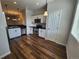 Modern kitchen featuring stainless steel appliances, white cabinets, and stylish pendant lighting at 12753 Ivanhoe St, Thornton, CO 80602