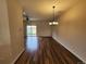 Spacious living area with wood floors, dining area, and access to backyard at 12753 Ivanhoe St, Thornton, CO 80602