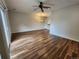 Bright living room with wood floors, dining area, and plenty of open space at 12753 Ivanhoe St, Thornton, CO 80602
