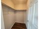 Walk-in closet with laminate floor and metal rods for hanging clothes offers storage and organization at 12753 Ivanhoe St, Thornton, CO 80602