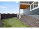 Backyard featuring green lawn, rock landscaping, and exterior deck structure at 21925 E 44Th Pl, Aurora, CO 80019