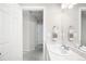 Well-lit bathroom features a sink with a marble countertop and a mirror reflecting the hallway at 21925 E 44Th Pl, Aurora, CO 80019
