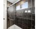Modern bathroom featuring frameless glass walk-in shower with gray tile surround at 21925 E 44Th Pl, Aurora, CO 80019