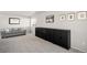 Spacious bonus room with neutral decor, large cabinet, and comfortable seating at 21925 E 44Th Pl, Aurora, CO 80019