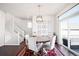Open dining room features modern chandelier, backyard patio, and staircase access at 21925 E 44Th Pl, Aurora, CO 80019