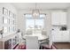 Bright dining room with modern lighting, backyard view, and built-in buffet at 21925 E 44Th Pl, Aurora, CO 80019