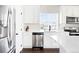Kitchen features stainless appliances, white cabinetry, quartz countertop, and modern faucet and accents at 21925 E 44Th Pl, Aurora, CO 80019