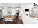 Bright kitchen with white cabinetry, stainless steel appliances, an island with seating, and wood flooring at 21925 E 44Th Pl, Aurora, CO 80019