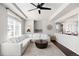 Comfortable living room with a large white sectional sofa, modern ceiling fan, and hardwood flooring at 21925 E 44Th Pl, Aurora, CO 80019