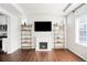 Bright living room with fireplace, floating shelves, and wood floors for a modern look at 21925 E 44Th Pl, Aurora, CO 80019