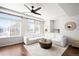 Inviting living room featuring a comfortable white sectional sofa, modern ceiling fan, and abundant natural light at 21925 E 44Th Pl, Aurora, CO 80019