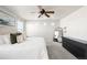 Main bedroom with carpet, ceiling fan, and bright windows with neighborhood views at 21925 E 44Th Pl, Aurora, CO 80019