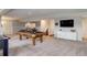 Finished basement features a pool table, stairs, and adjacent living space at 2434 Hearth Dr # C1, Evergreen, CO 80439