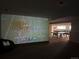 Finished basement with a projector screen and a ping pong table at 2434 Hearth Dr # C1, Evergreen, CO 80439