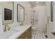 Bright bathroom featuring double vanity with quartz countertops and a modern shower-tub combination at 2434 Hearth Dr # C1, Evergreen, CO 80439