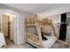Rustic bedroom features a bunk bed with log frame and an organized closet at 2434 Hearth Dr # C1, Evergreen, CO 80439