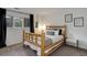 Charming bedroom featuring a log frame bed, neutral tones and abundant natural light at 2434 Hearth Dr # C1, Evergreen, CO 80439