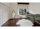 Bright Bedroom featuring hardwood floors, a window seat, and a comfortable crib at 2434 Hearth Dr # C1, Evergreen, CO 80439