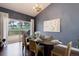 Elegant dining room with a modern chandelier and sliding glass doors leading to an outdoor deck at 2434 Hearth Dr # C1, Evergreen, CO 80439