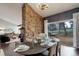 Open dining area with a stone wall accent, stylish decor, and seamless transition to the living space at 2434 Hearth Dr # C1, Evergreen, CO 80439