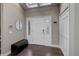 Bright foyer featuring hardwood floors, a modern bench, and ample closet space at 2434 Hearth Dr # C1, Evergreen, CO 80439