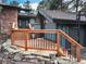 Inviting front entrance featuring a wood porch, wood steps, stone retaining wall, and a landscaped yard at 2434 Hearth Dr # C1, Evergreen, CO 80439