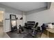 Home gym area with weights, exercise equipment, and dark flooring at 2434 Hearth Dr # C1, Evergreen, CO 80439