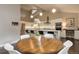 Bright, open kitchen with an island and modern appliances, seamlessly connected to the dining area at 2434 Hearth Dr # C1, Evergreen, CO 80439
