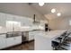 Modern kitchen featuring white cabinetry, stainless steel appliances, and a spacious center island with seating at 2434 Hearth Dr # C1, Evergreen, CO 80439