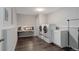 Well-lit laundry room with stacked washer and dryer, tile floor, and storage at 2434 Hearth Dr # C1, Evergreen, CO 80439