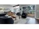 Cozy living room featuring hardwood floors, stylish furniture, and access to an outdoor deck at 2434 Hearth Dr # C1, Evergreen, CO 80439