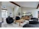Bright, modern living room featuring vaulted ceilings, a cozy seating arrangement, and neutral decor at 2434 Hearth Dr # C1, Evergreen, CO 80439