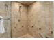 Tiled shower stall with built-in seat and handheld shower head at 2434 Hearth Dr # C1, Evergreen, CO 80439