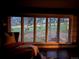 Picturesque view of wildlife and trees from a cozy chair by a large window at 2434 Hearth Dr # C1, Evergreen, CO 80439
