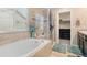 Bright bathroom boasts a soaking tub, glass shower, and large window with sun-filtering blinds at 5161 Chicory Cir, Brighton, CO 80601