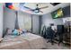 Relaxing gray bedroom with a ceiling fan and a large sunny window at 5161 Chicory Cir, Brighton, CO 80601