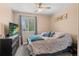 Bedroom with a ceiling fan, patterned bedding and a large window at 5161 Chicory Cir, Brighton, CO 80601