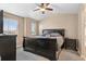 Comfortable bedroom featuring a large bed, plush carpet, and natural light from two windows at 5161 Chicory Cir, Brighton, CO 80601