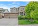 Charming two-story home with a three-car garage, covered entry, and well-manicured front lawn at 5161 Chicory Cir, Brighton, CO 80601