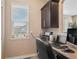 Cozy home office nook with a built-in desk, storage cabinet, and a bright window at 5161 Chicory Cir, Brighton, CO 80601