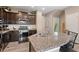 This kitchen offers granite counters, stainless steel appliances, and a stylish island with bar seating at 5161 Chicory Cir, Brighton, CO 80601