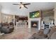 Open-concept living room with a fireplace, modern furnishings, and seamless access to the kitchen at 5161 Chicory Cir, Brighton, CO 80601