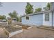 Backyard view features garden, cottage, and outdoor access into the home at 233 N 10Th Ave, Brighton, CO 80601